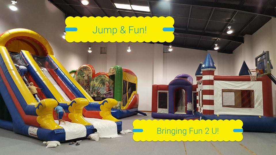 Indoor inflatable play area with bounce houses and large inflatable slides at Inflatable Fun-Plex in Oakdale, Louisiana